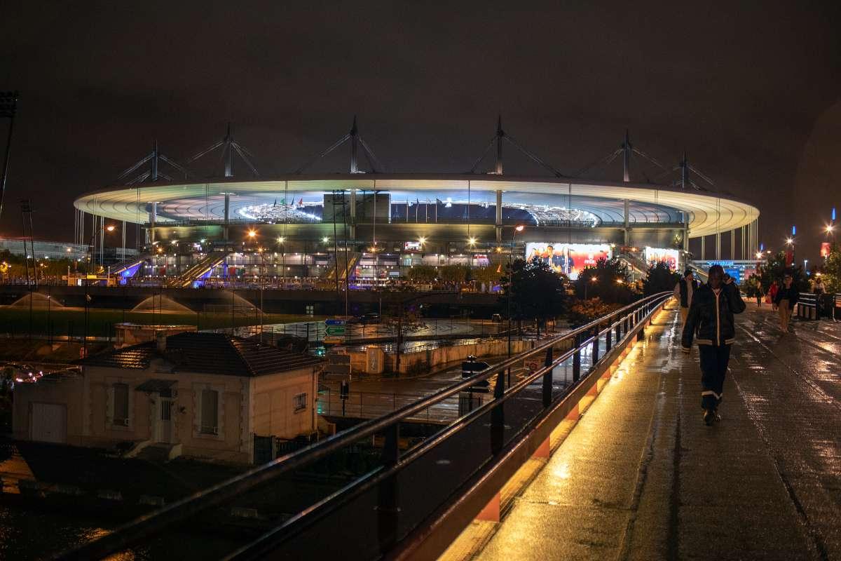 An exterior shot of the Stade de France at night time.