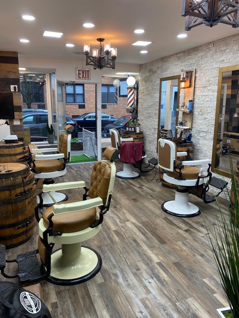 Do traditional barbershops in NYC and Boston offer any additional services such as hot towel shaves or beard trims?