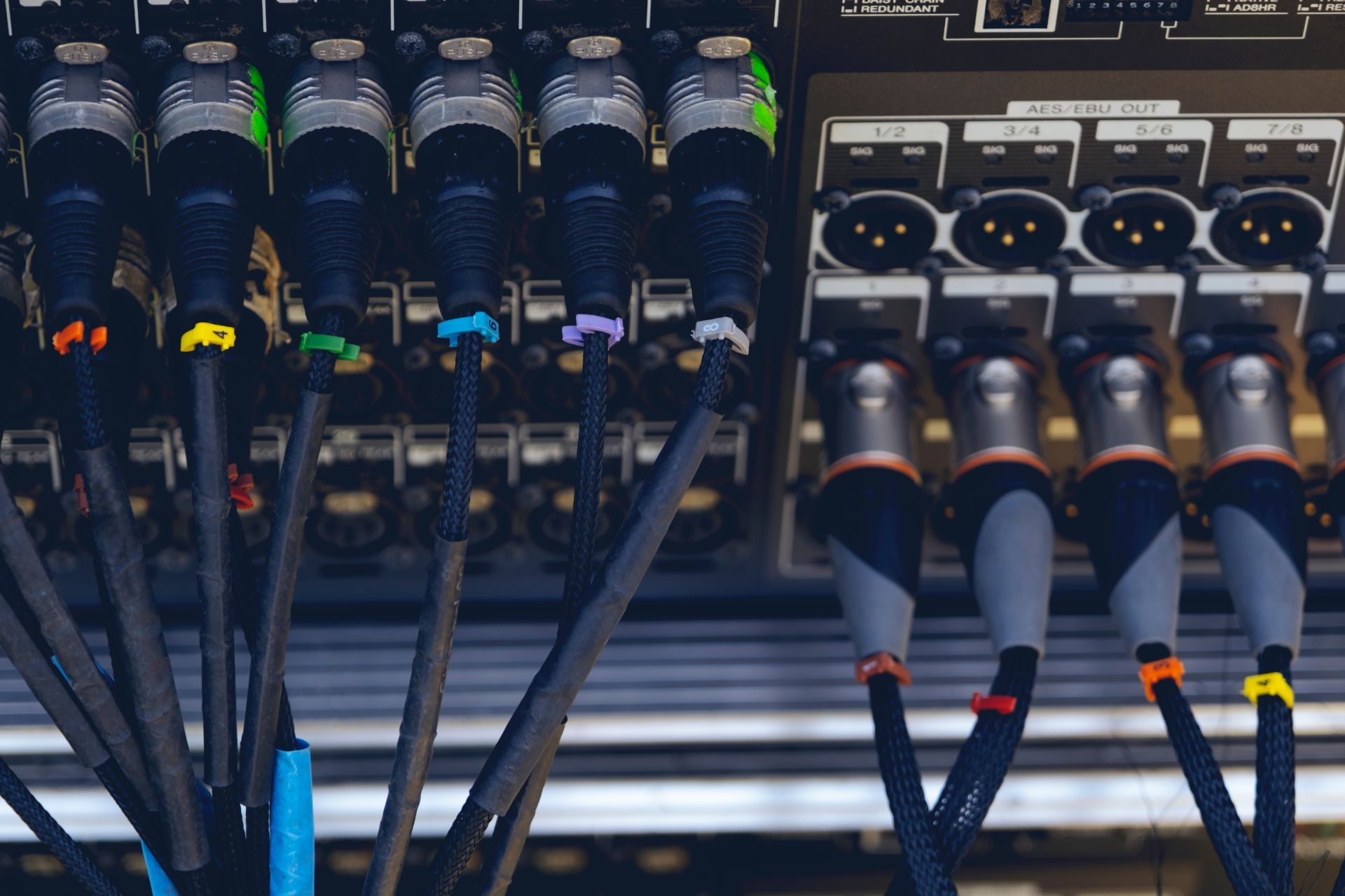 What are the potential consequences of using unbalanced audio line-level signals in a professional audio setup?