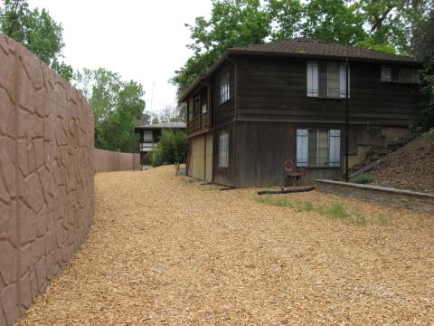 The front side of the floodwall facing the backyard of a home on Arroyo Way.