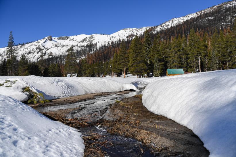 Snow melts into a creek that flows into the South Fork American River, near the site of the California Department of Water Resources second media snow survey of the 2022 season in the Sierra Nevada Mountains.