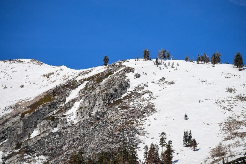 Mountain peaks are covered with snow near the Phillips Station meadow on March 1, 2022.