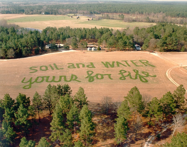 Soil and Water For Life spelled out in agricultural field