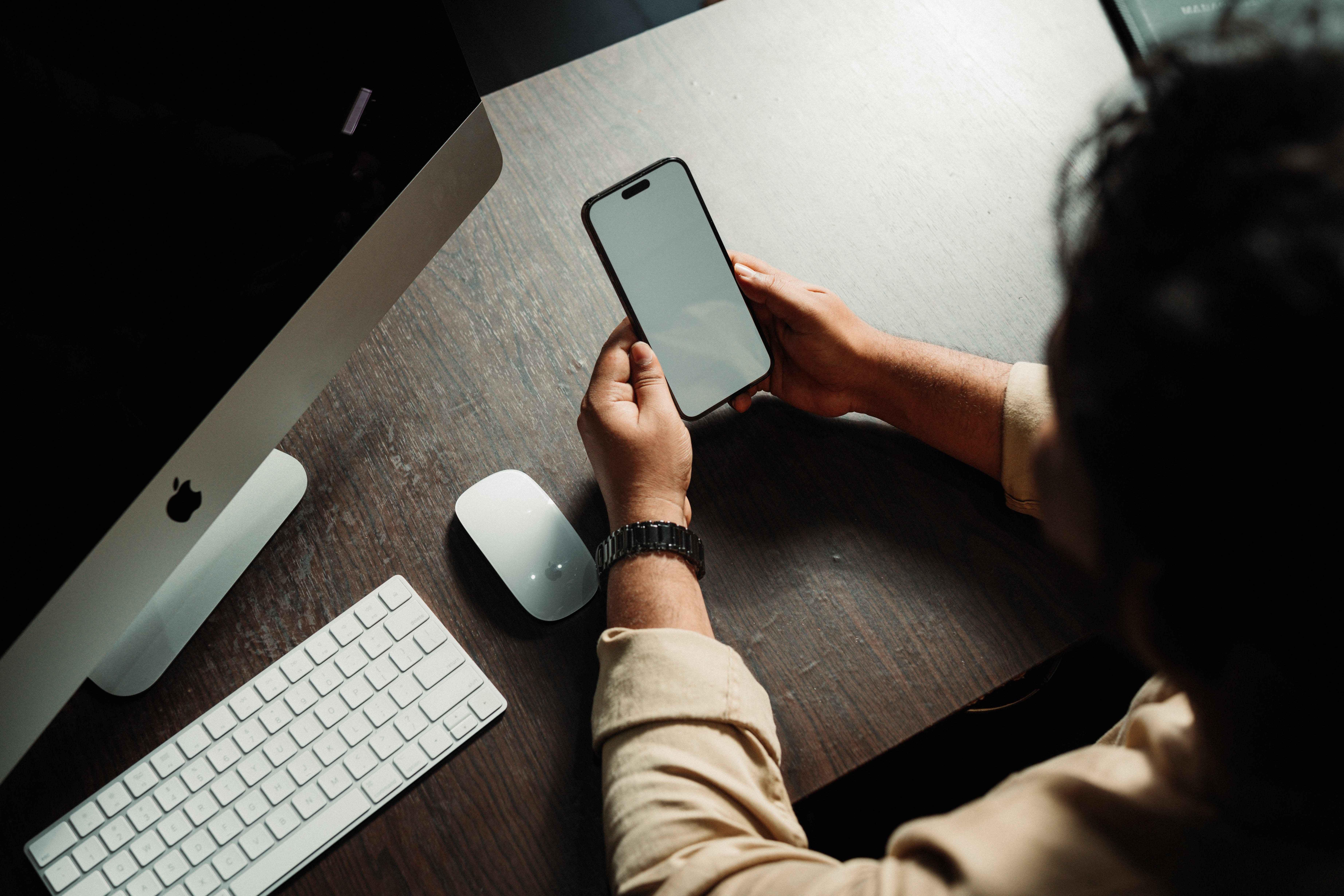 computer and person holding a phone