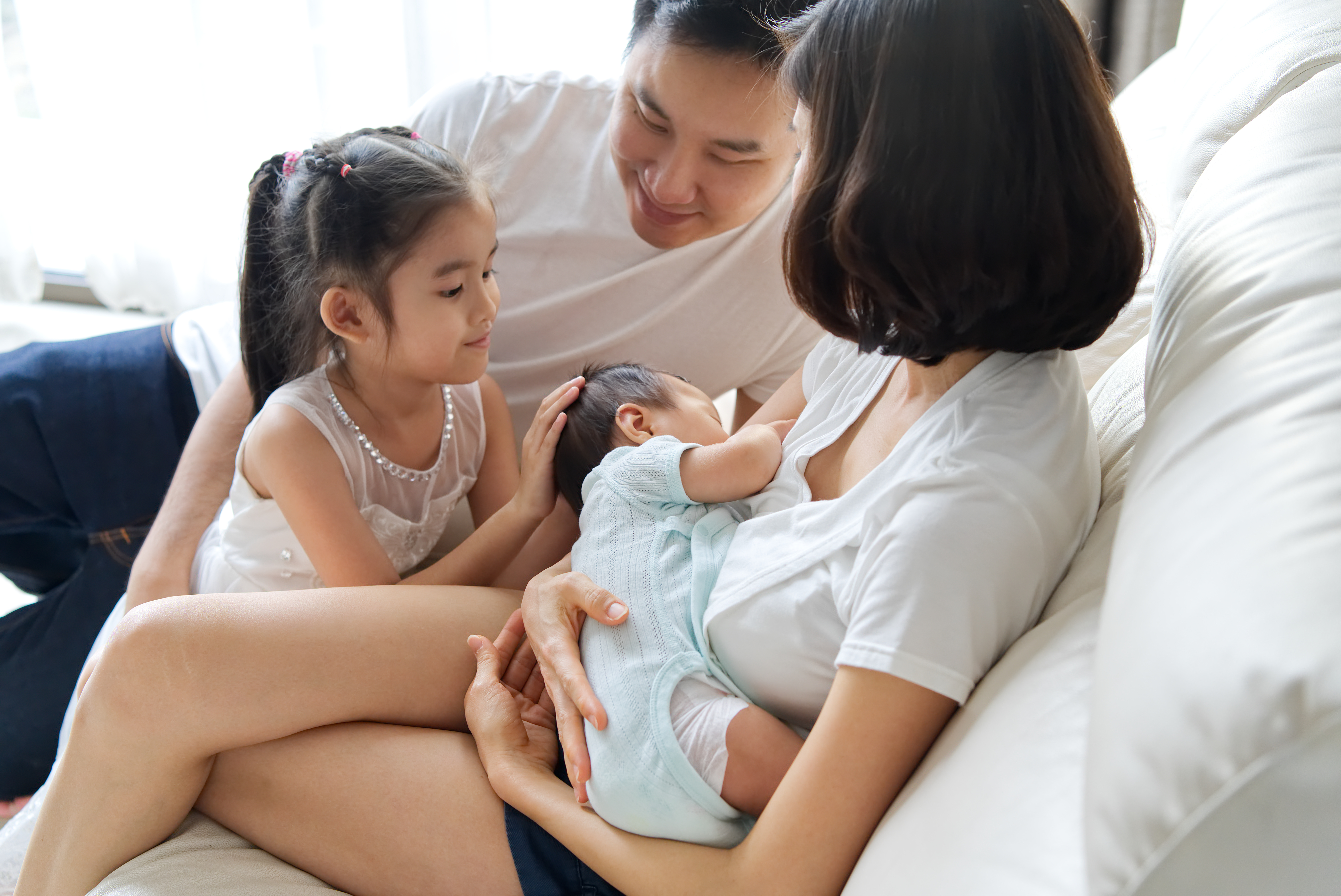 Asian family with mom breastfeeding infant 