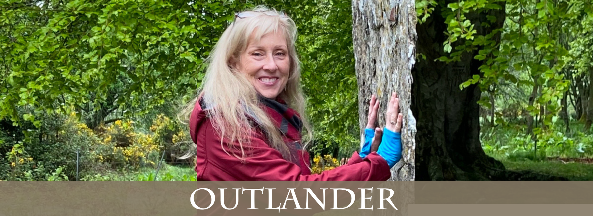 Presenter Dawn Woo leaning against a standing stone in Scotland