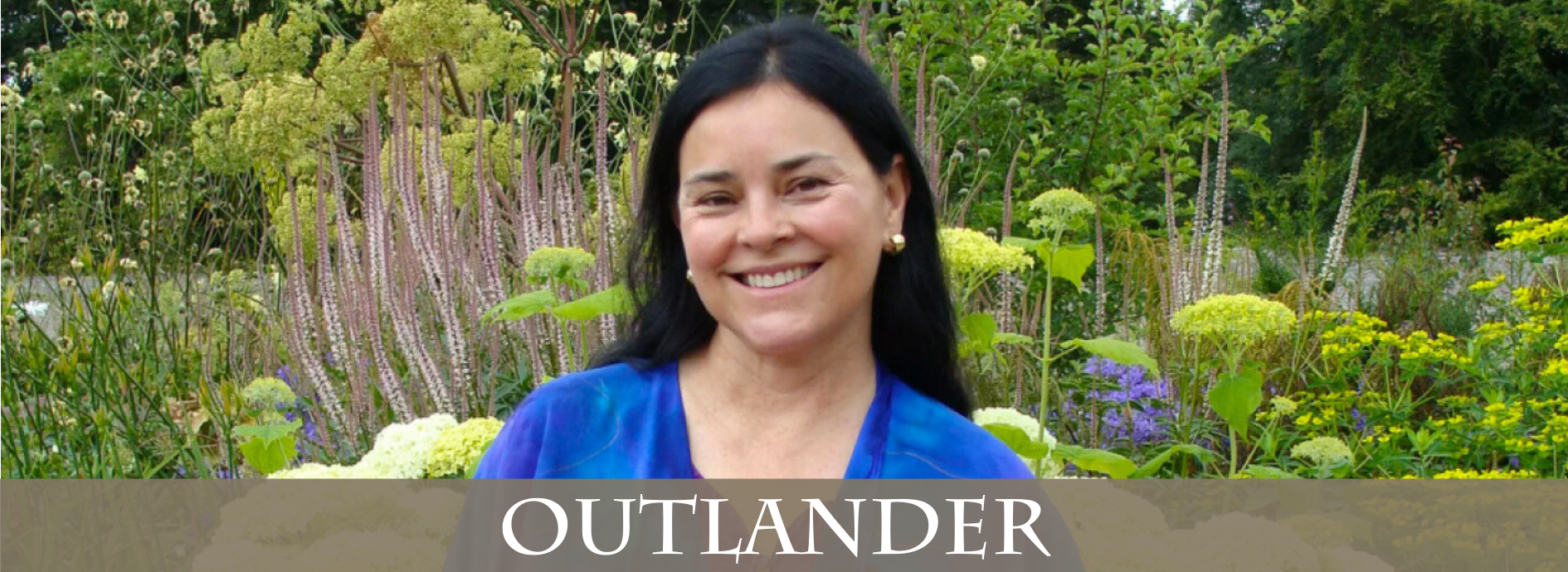 Author Diana Gabaldon smiling and looking lovely in a garden