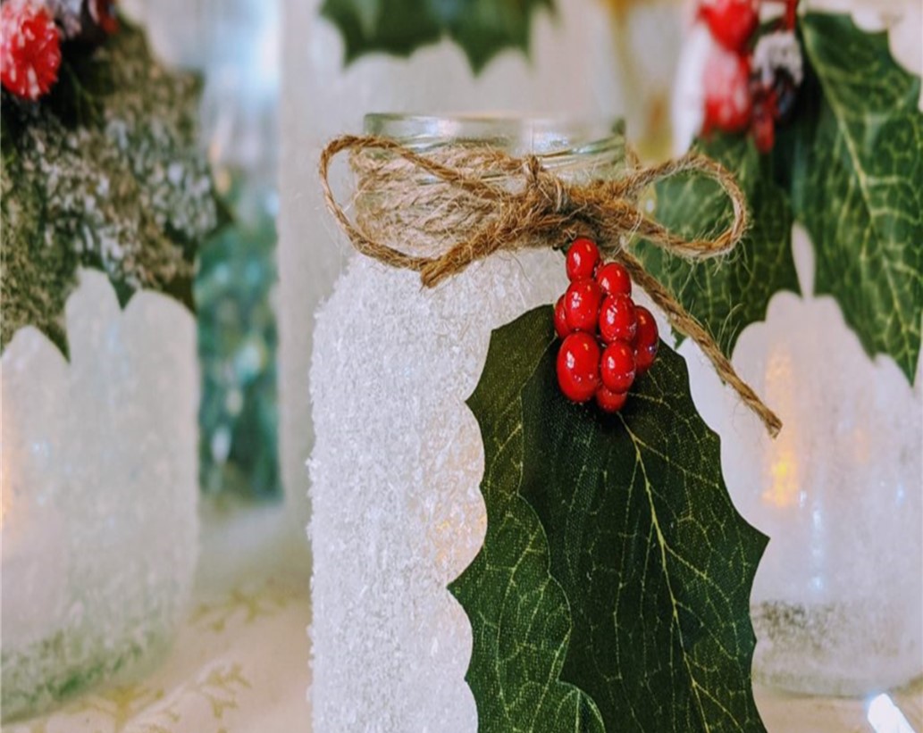 a luminary candle with holly