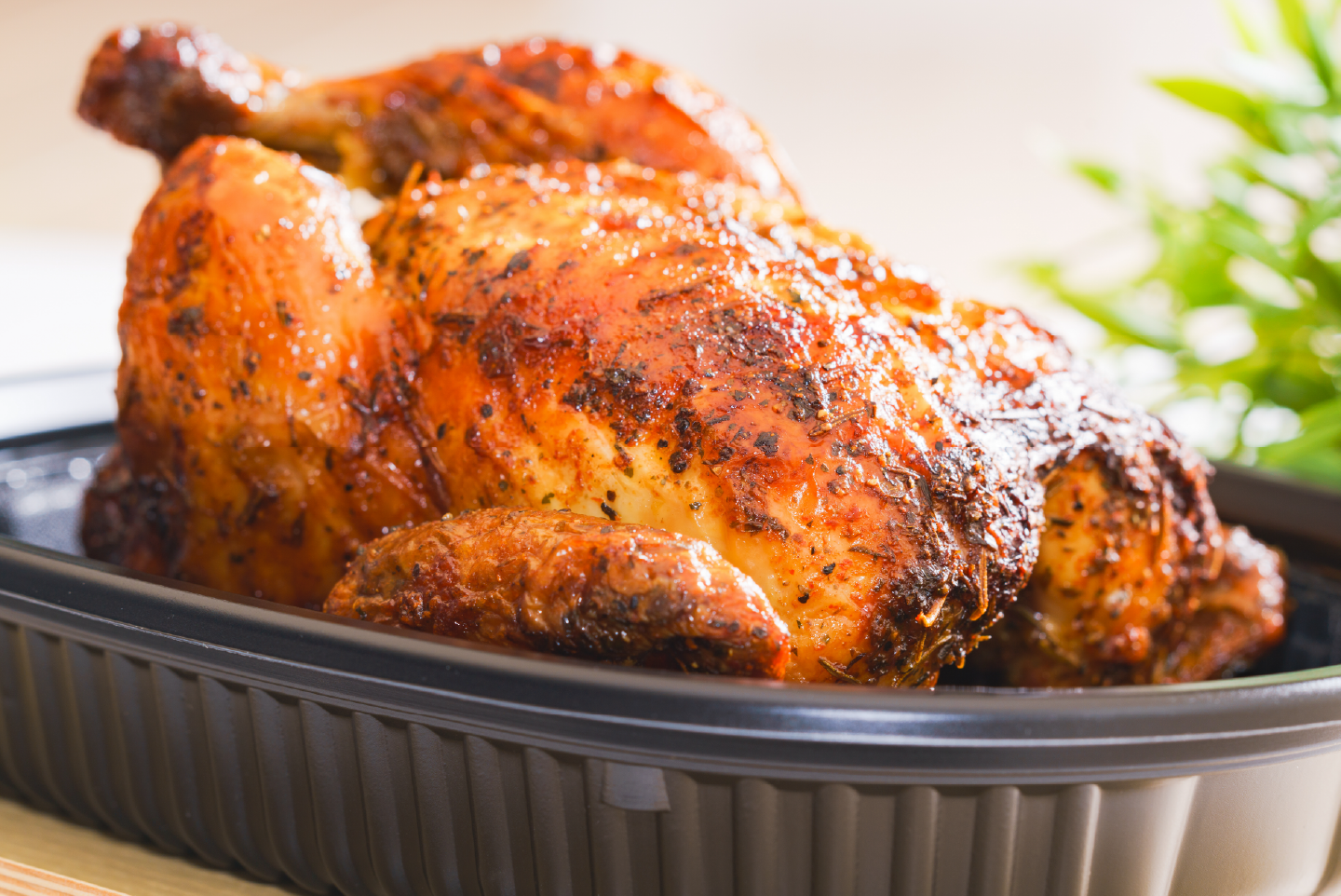 a storebought rotisserie chicken in a plastic container