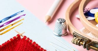 Picture of embroidery hoop, needles, knitting, and crochet hooks