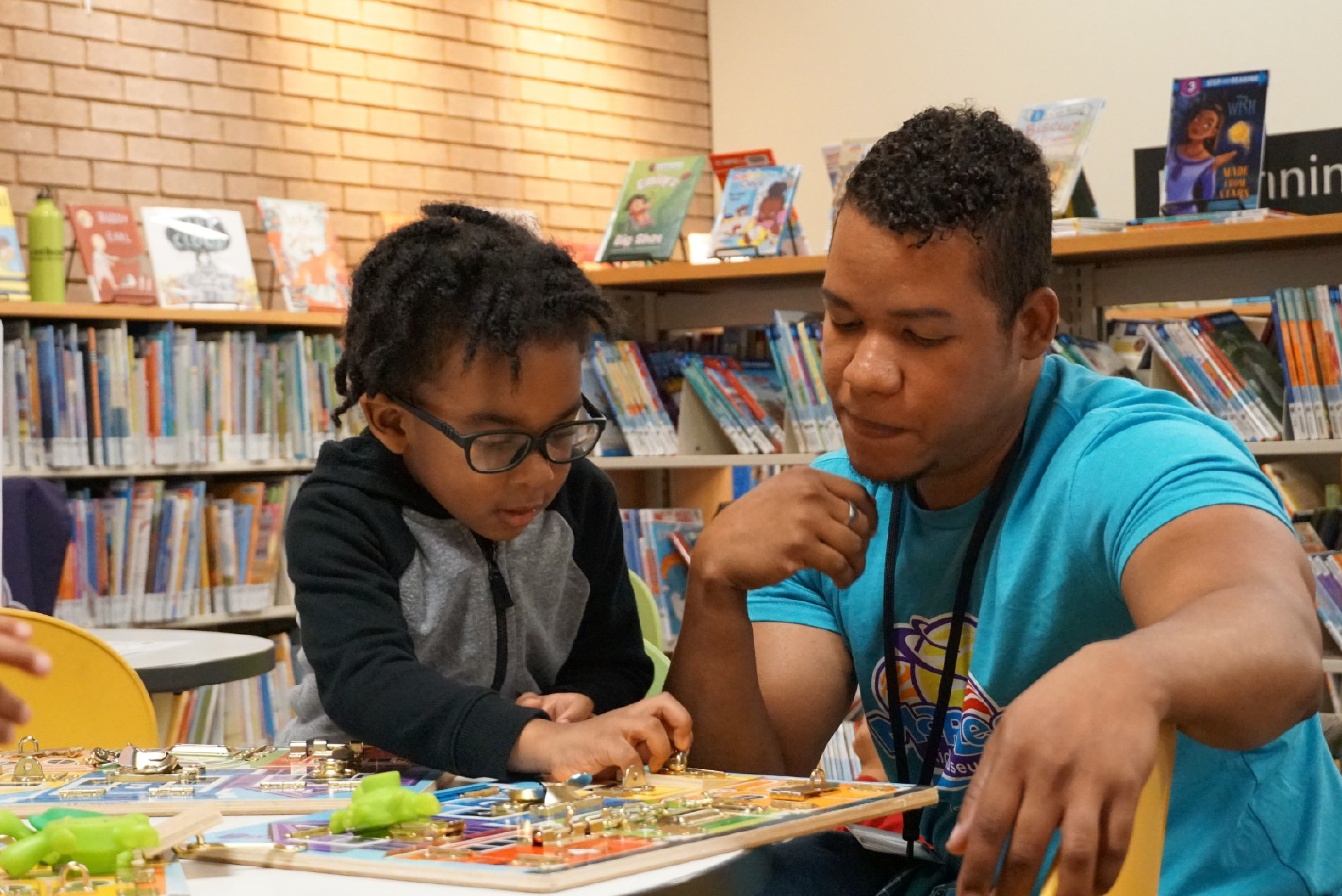 Adult and young child playing a board game