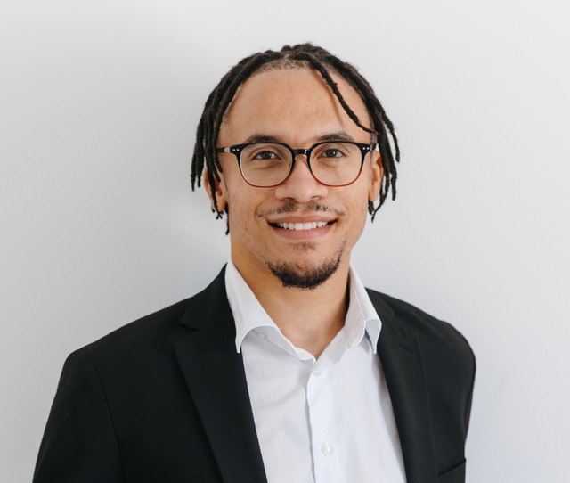 Smiling man wearing glasses.