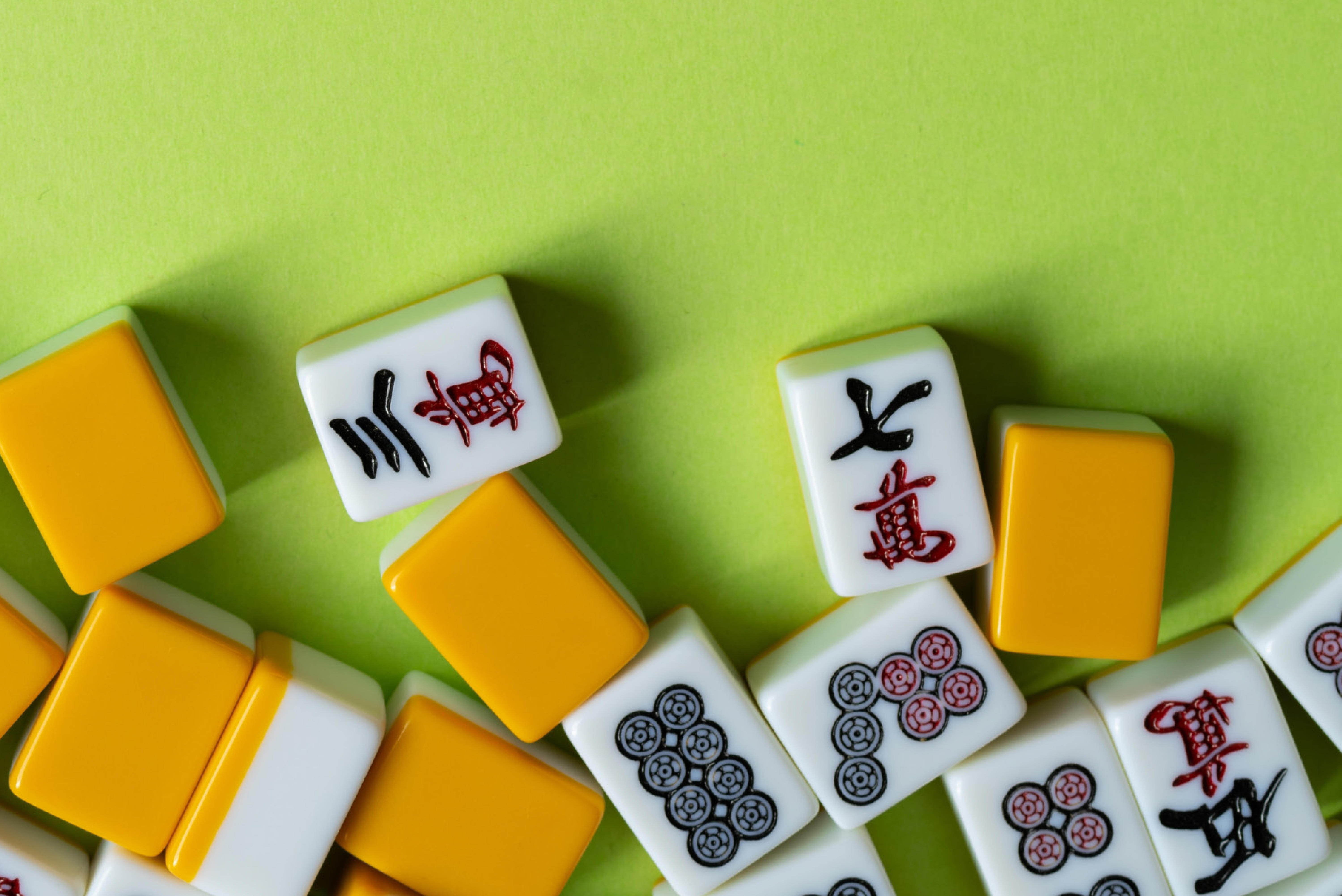 image of green background with scattered Mah Jongg tiles