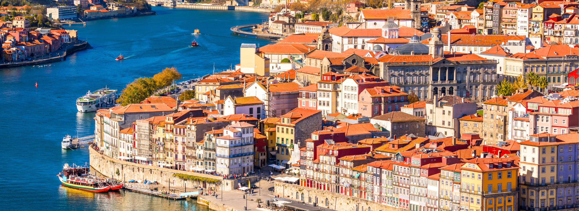 View of Porto, city in Portugal showing river and colorful buildings.