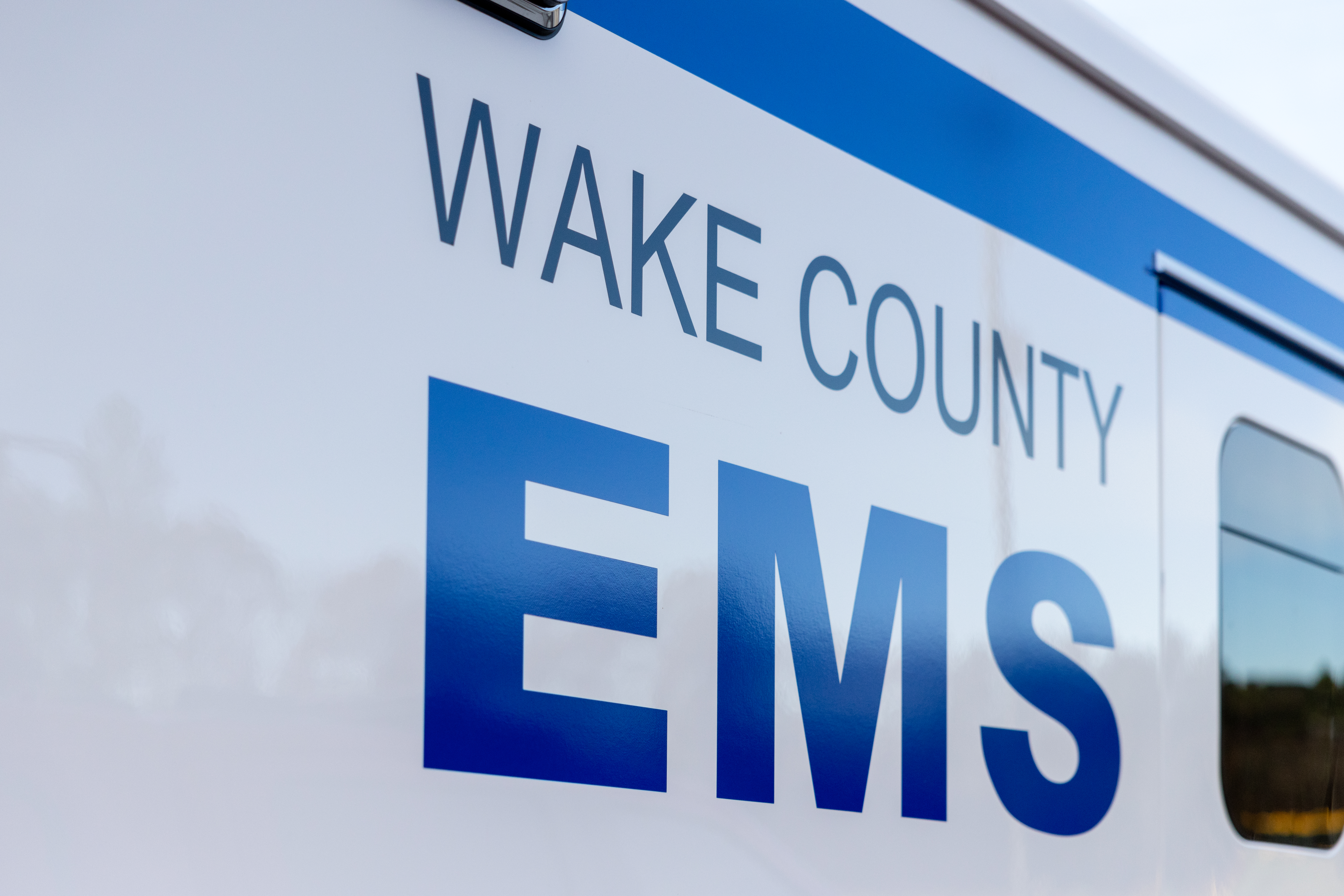 Close-up of the Wake County EMS logo displayed on the side of an ambulance.
