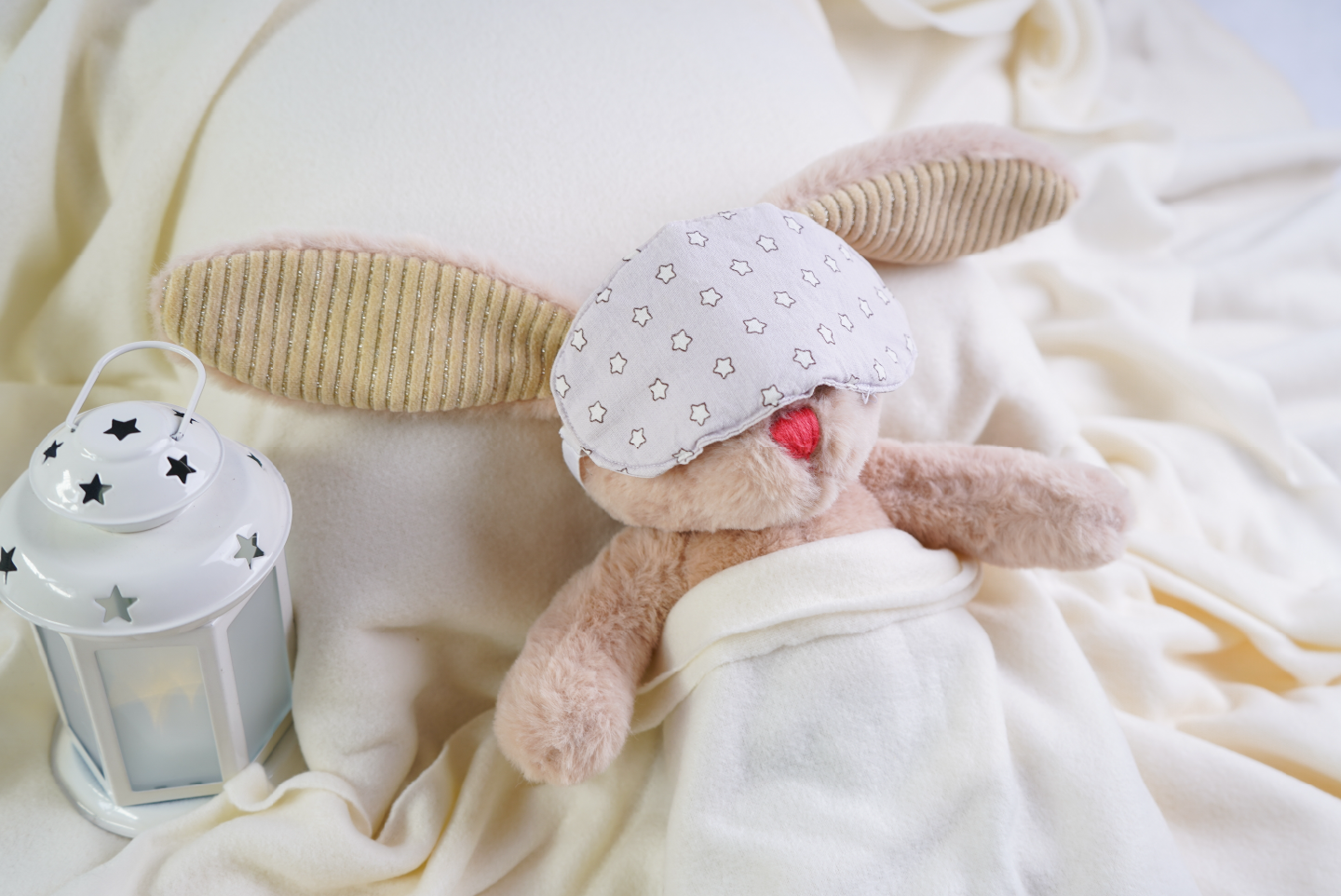 a sleeping stuffed bunny, complete with sleep mask 