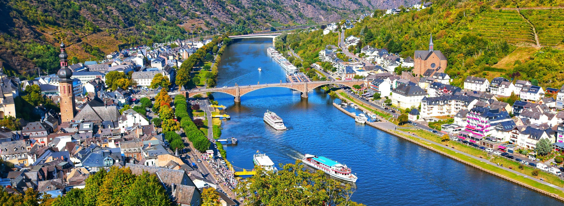 Two boats on the danube river with a small village on left bank.