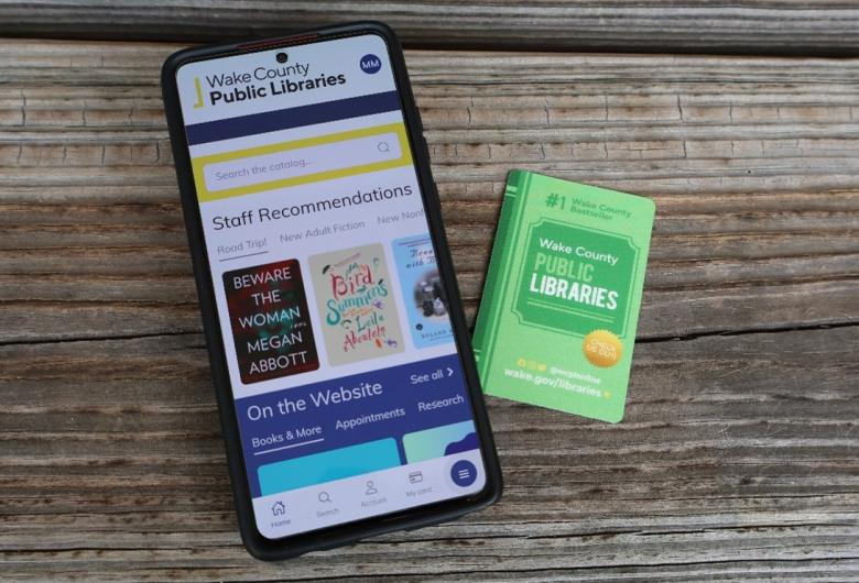phone with WCPL Mobile app and library card