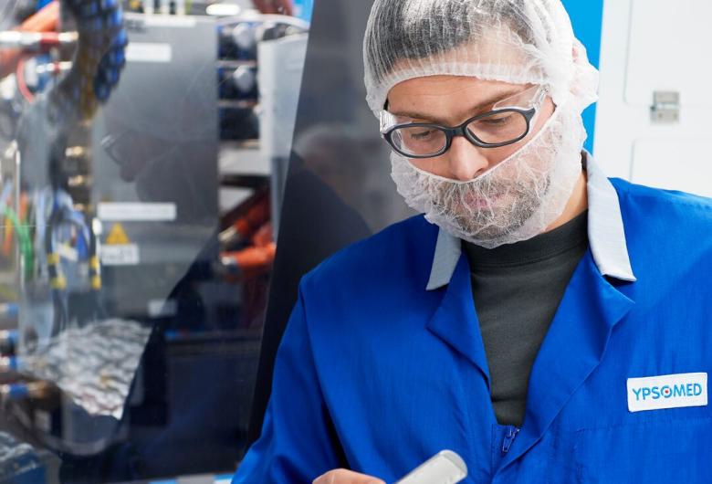 Lab technician looks at a sample