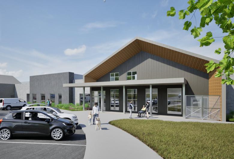 Architectural rendering of a modern animal shelter entrance with a covered porch, large windows, and gray exterior walls.