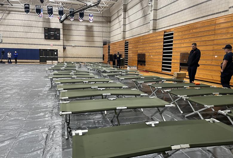 shelter inside Southeast Raleigh High School gym, with cots set up