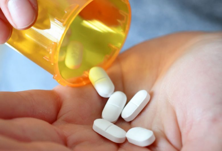 Hands holding pill bottle