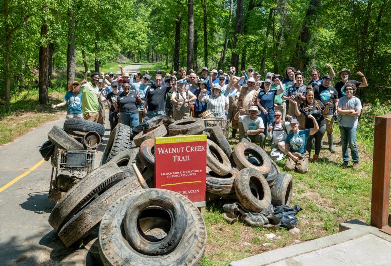 Volunteers posing with trash collected from Walnut Creek