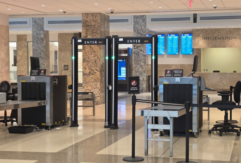 Security screening area inside a Wake County building with metal detectors and x-ray equipment.