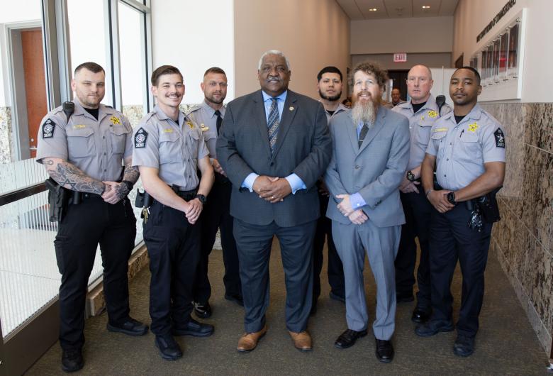 Sheriff Willie Rowe stands with six deputies and the man they helped when he had a medical emergency. 