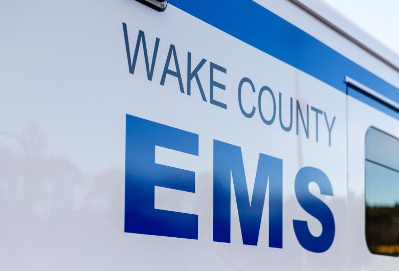 Close-up of the Wake County EMS logo displayed on the side of an ambulance.