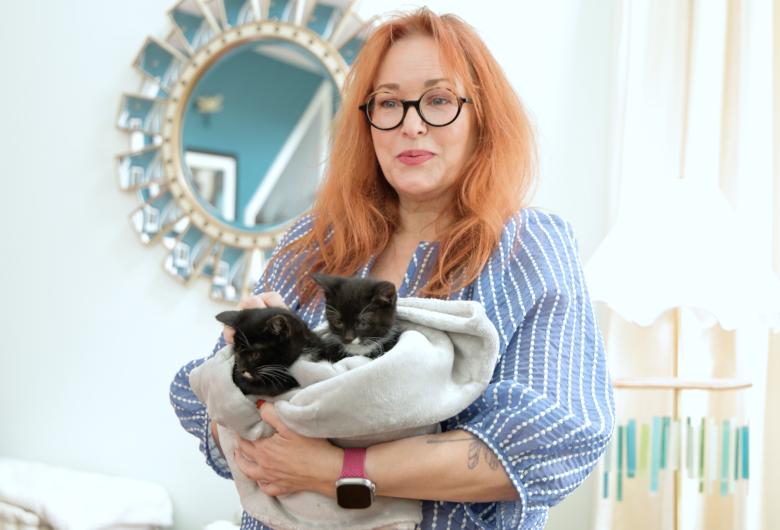 Elle caring for foster kittens in her home
