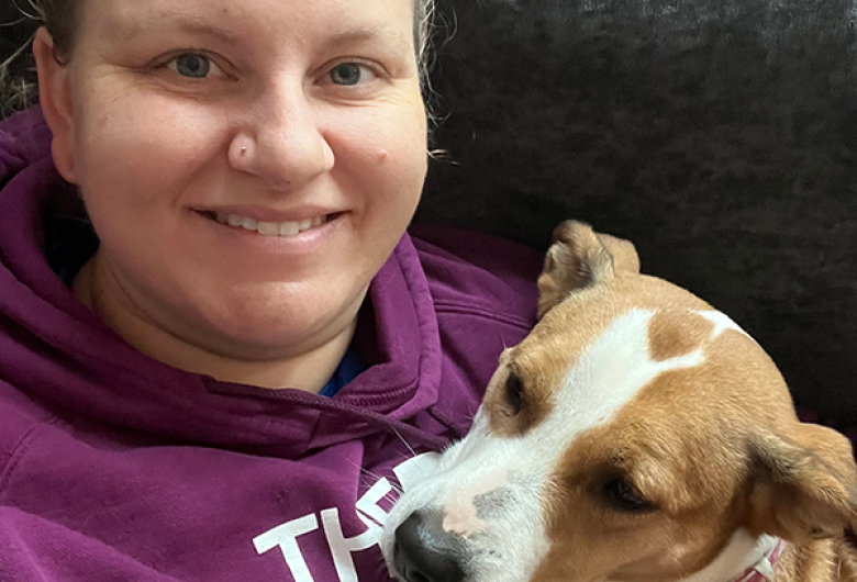 Justine Henderson cuddles with Mae on a couch.