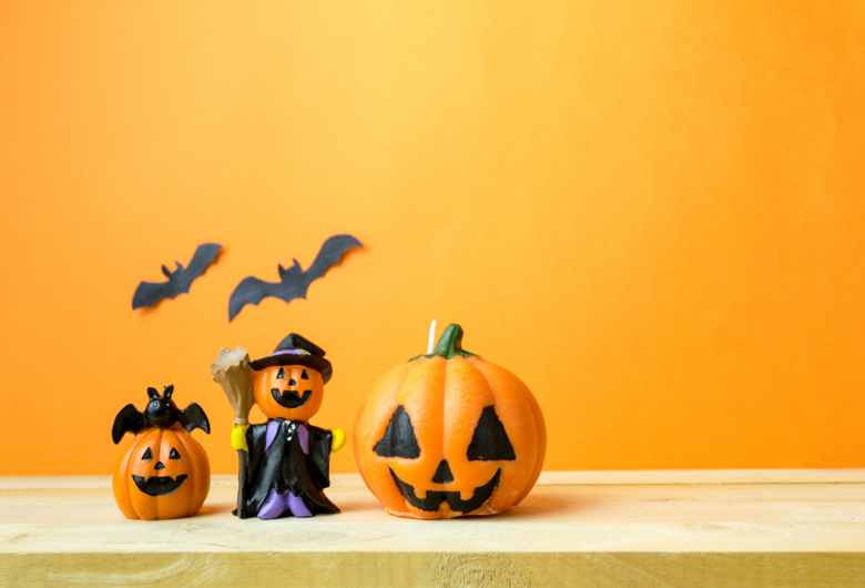 three bats, three pumpkins, one of which is dressed as a witch
