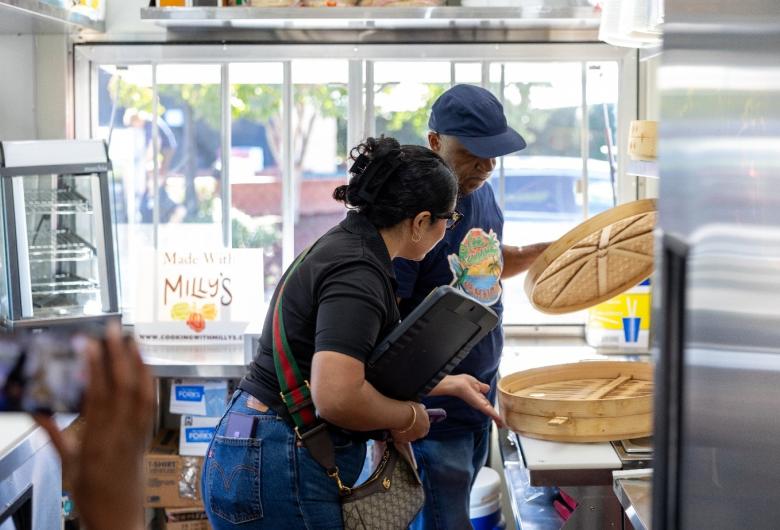 Public Health inspector checks cooking equipment