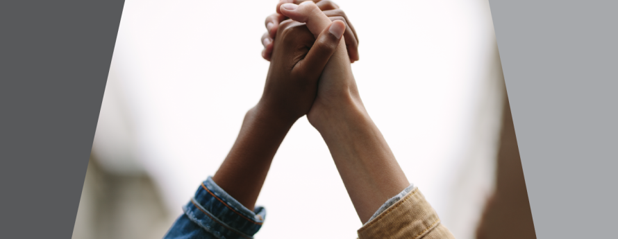 hands clasped together; one white, one black