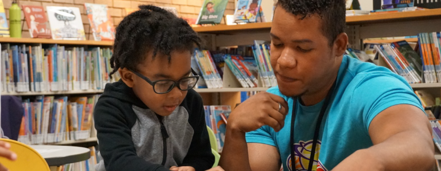 Adult and young child playing a board game