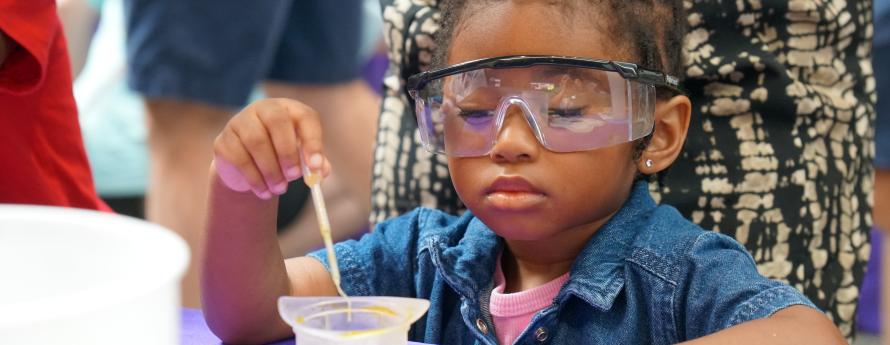 young child doing a science experiment