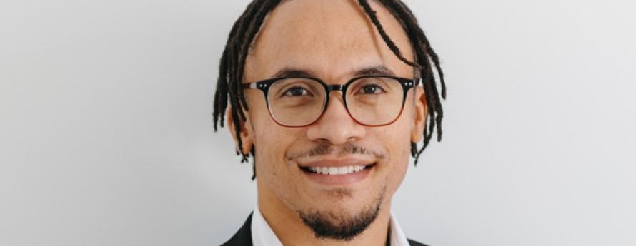 Smiling man wearing glasses.