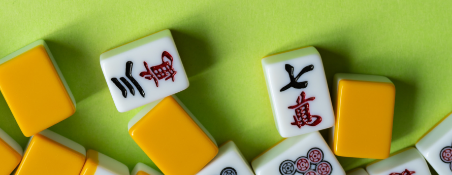 image of green background with scattered Mah Jongg tiles