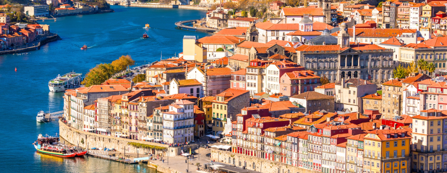 View of Porto, city in Portugal showing river and colorful buildings.