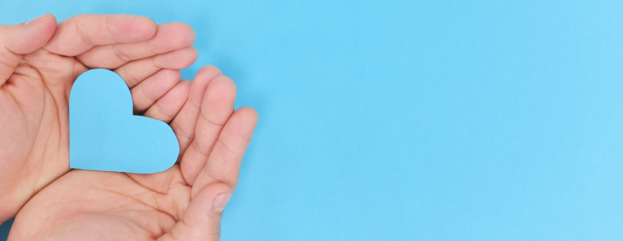 light blue background with cupped hands holding a light blue heart