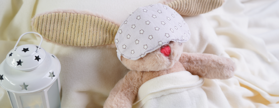 a sleeping stuffed bunny, complete with sleep mask 