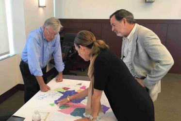 Planners review a map on a table