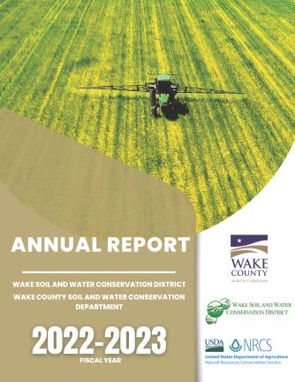 Tractor with sprayer in crop field.