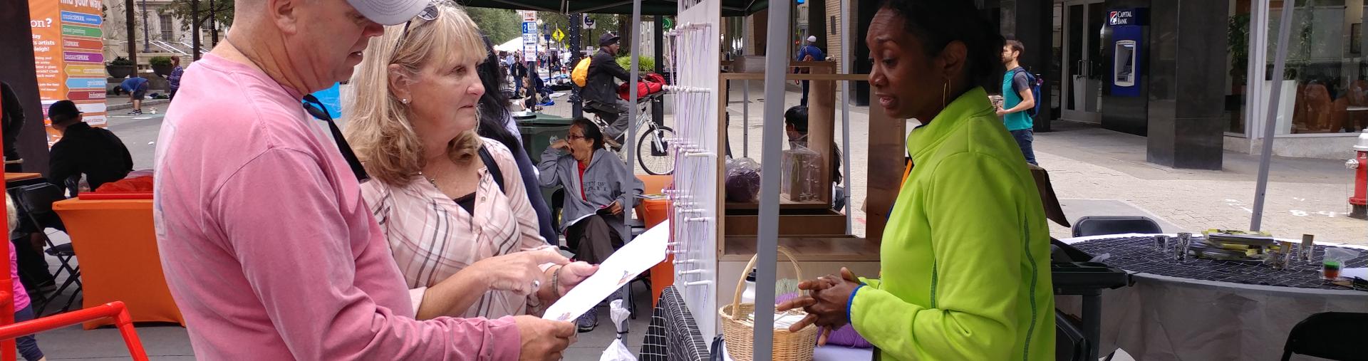 Residents take a survey at a festival.