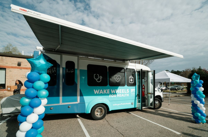 Public health mini bus shown at ribbon cutting