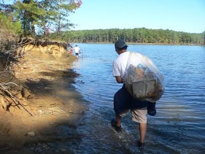 Man carrying bag of litter.