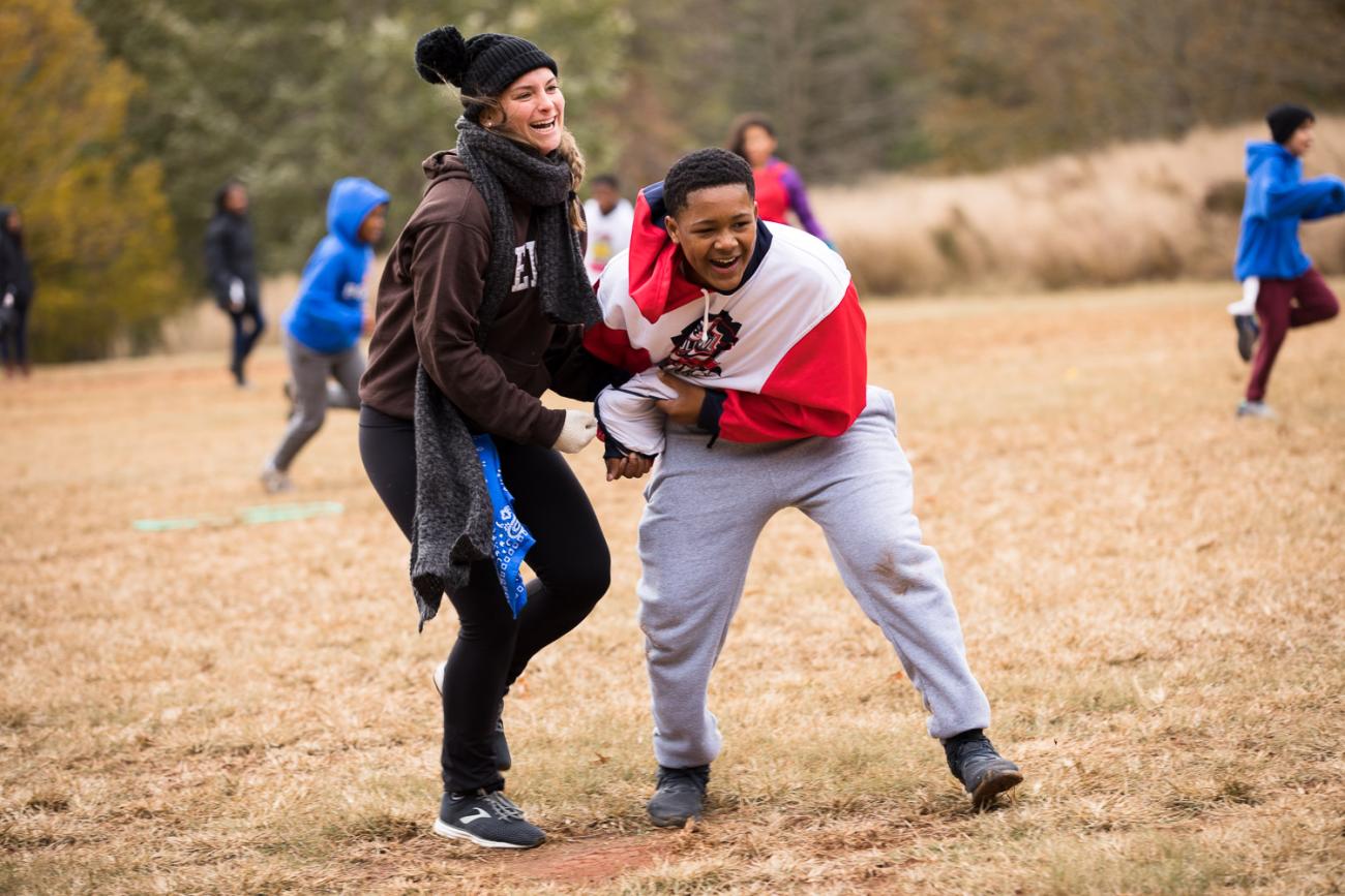 Kids playing tag on open play field