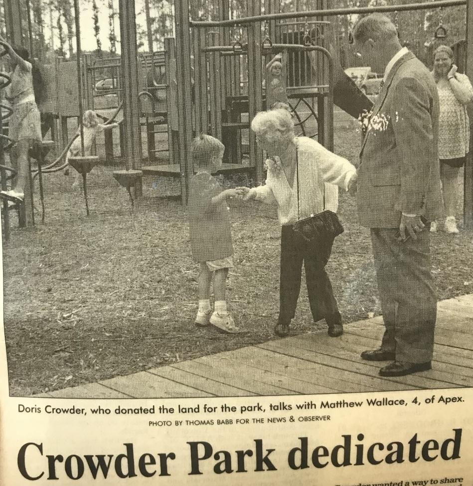 Newspaper clip of Doris Crowder with child at playground at park opening