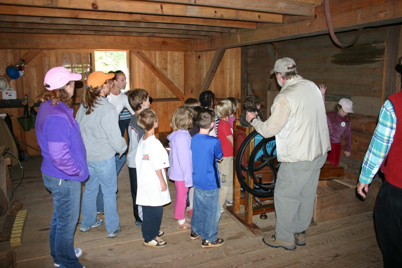 tour group stands inside of old historic mill building